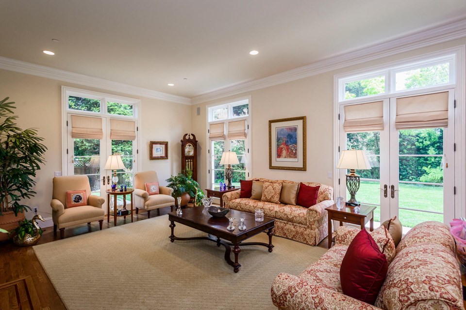elegant formal living room with fireplace opens to dining room