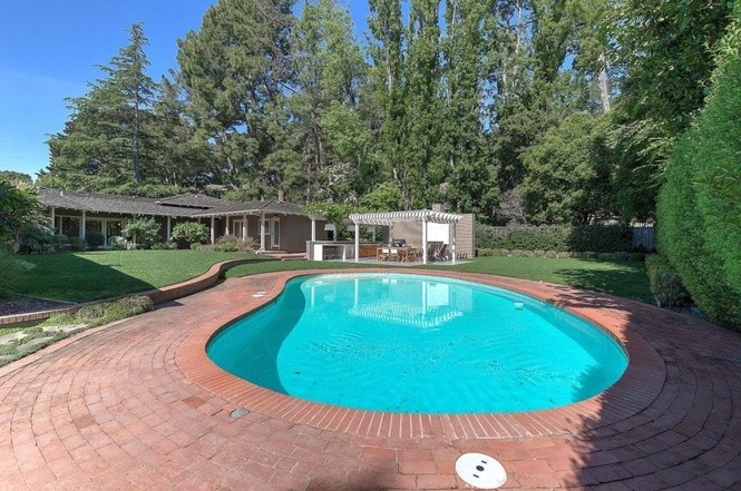 beautiful level yard with large pool and grassy play area