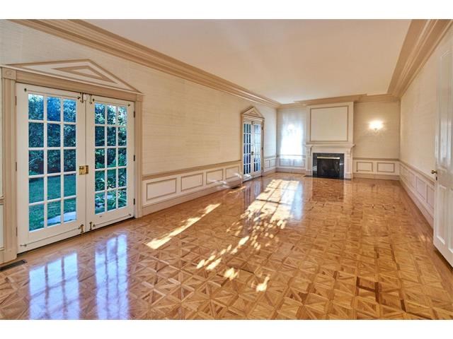 large formal living room with french doors leading to grassy play area