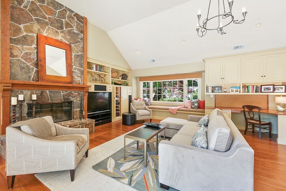 adjacent family room with oversized glass doors leading to yard